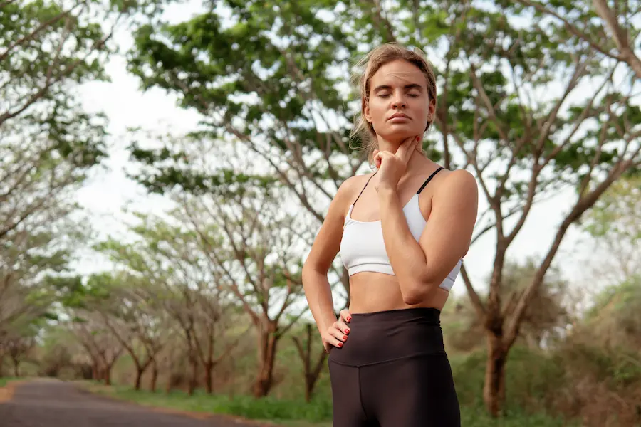 Corredora realizando técnicas de respiración antes de salir a correr