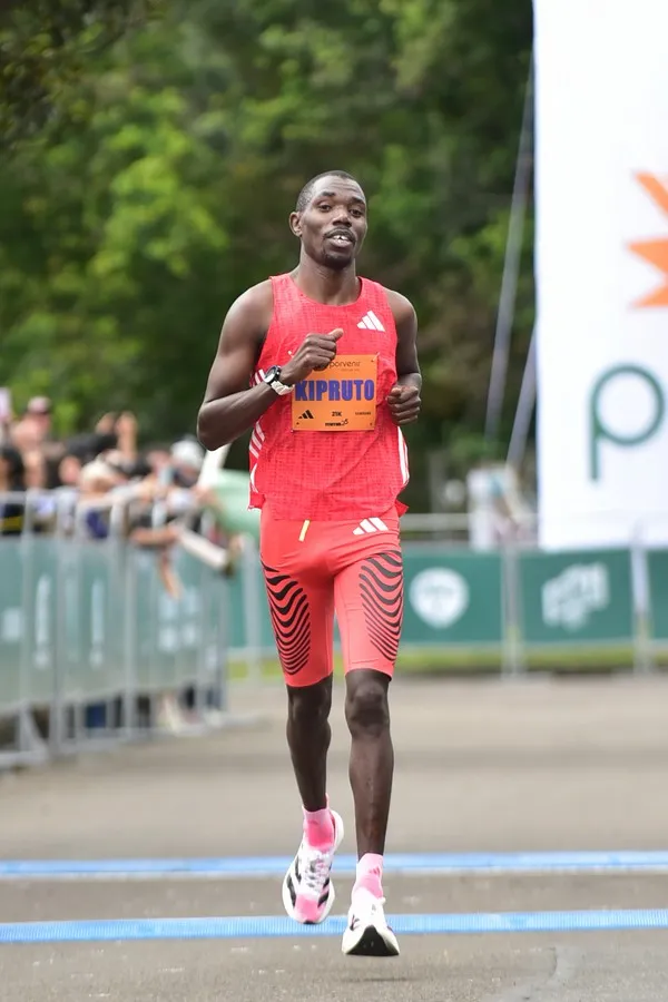 Runner manteniendo pace disciplinado resistiendo tentación de acelerar en inicio de carrera