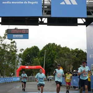 Grupo de corredores cruza la línea final de la Media Maratón.